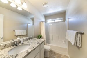 Bathroom with grey and white countertops and white fixtures