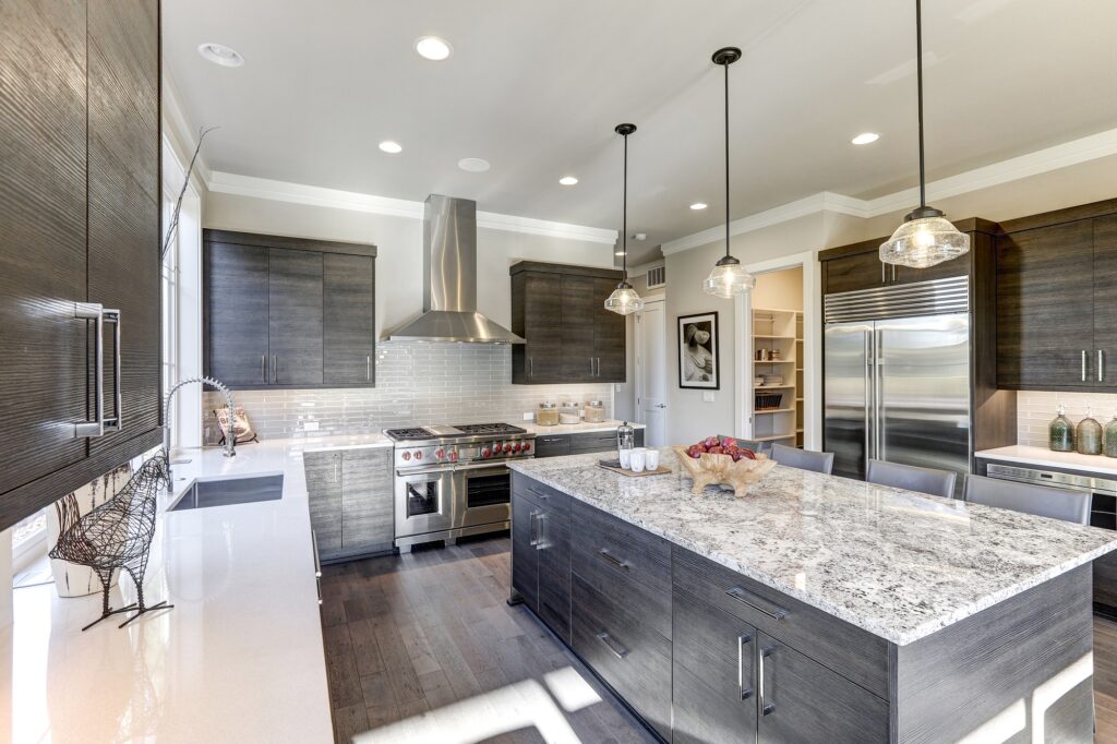 Modern kitchen featuring dark gray cabinets paired with white quartz countertops 